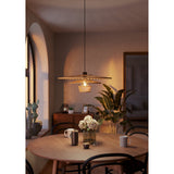 Frimorne Wooden Pendant Light in black steel with layered honey-toned wooden slats, hung above a round dining table in a living room setting.
