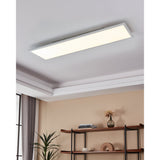 Frinarne LED Panel Light 33W, 120 x 30 x 5cm, white rectangular ceiling-mounted panel with a flat white diffuser, shown recessed into a living room ceiling above a shelf unit.