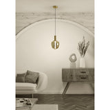 Fruitera Glass Pendant Light 21cm in brushed brass with an apple-shaped amber glass shade, hanging above a wooden sideboard in a neutral living room setting.