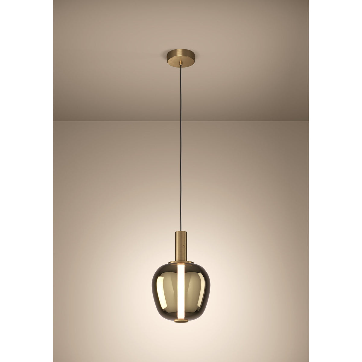 Fruitera Glass Pendant Light 25cm in Brushed Brass, with an apple-shaped gold vaporised glass shade and central LED tube, hung from a black cord and round ceiling canopy against a plain background.