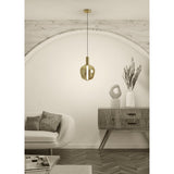 Fruitera Glass Pendant Light 25cm in Brushed Brass with apple-shaped gold glass shade and integrated LED, hung above a console table in a living room setting.