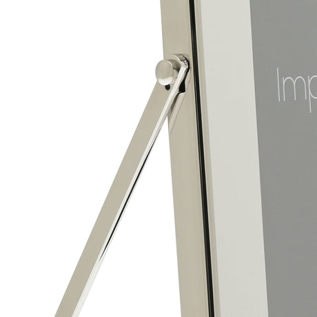 Close-up of the silver photo frame's hinged strut stand and white mount edge, shown against a plain white background.