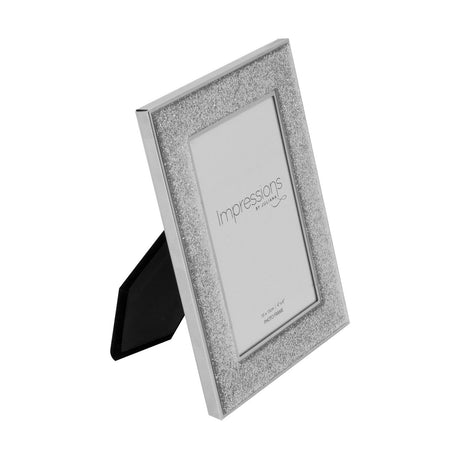 Freestanding single photo frame with a wide silver glitter band and slim silver rim, shown at an angle with rear stand, on a plain white background.