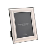 Silverplated rectangular metal photo frame with a broad satin silver border and polished edge lines, holding an 8 x 6in photo, shown at an angle on a plain white background.