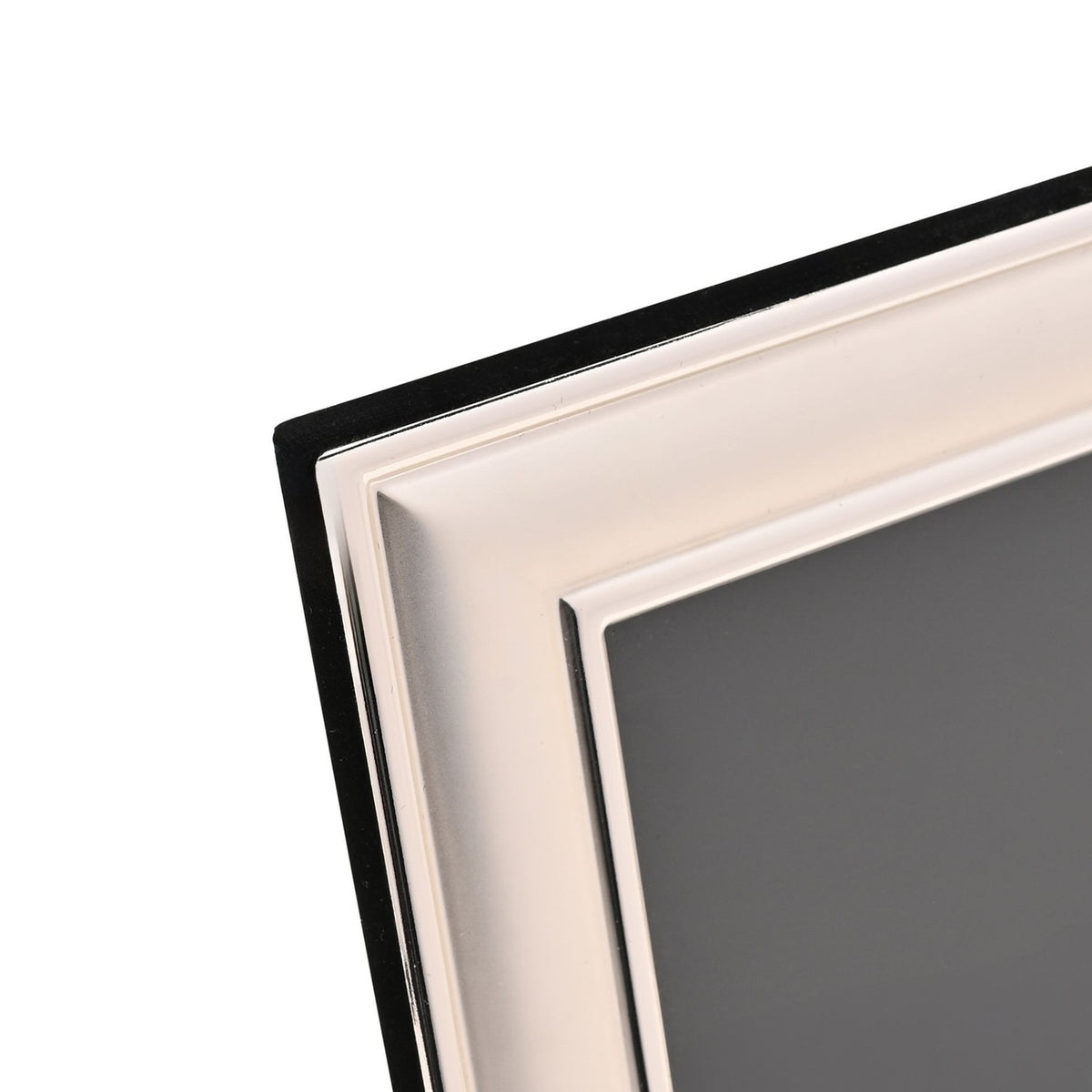 Close-up of the Silverplated Border Edge Metal Photo Frame 8 x 6in corner, showing a satin silver band with polished edge lines against a black backing, on a plain white background.
