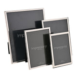 Four silverplated rectangular photo frames in varying sizes with thin crackled-texture borders, standing upright on a plain white background.