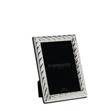 Silverplated rectangular photo frame with diagonal swirl textured border, bright silver finish, black backing and stand, shown against a plain white background.