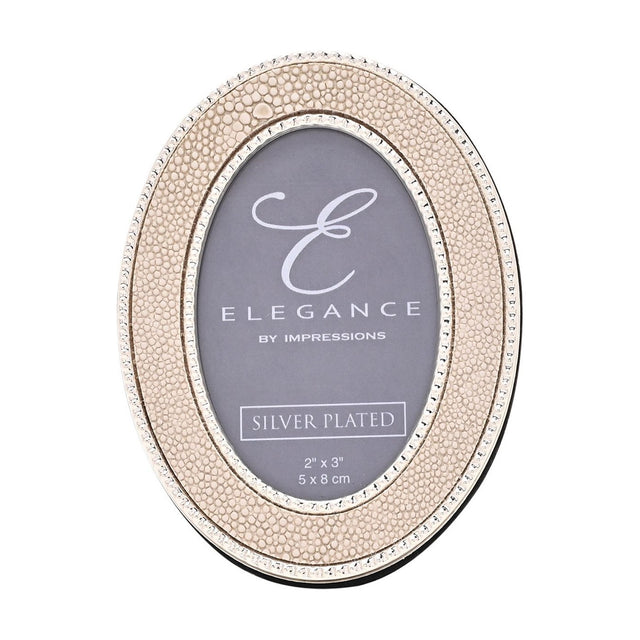 Oval photo frame with cream faux shagreen texture, silver-plated beaded edging, and a 2x3in opening, shown on a plain white background.
