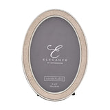 Oval photo frame with cream faux shagreen border and silver-tone beaded edges, holding a 6 x 4in photo, shown on a plain white background.
