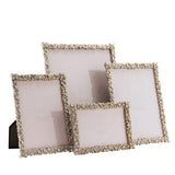Four rectangular metal photo frames in varying sizes, each with a jewelled silver floret border and clear faceted stones, shown on a plain white background.