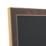 Close-up of a rectangular photo frame corner with a brown tortoiseshell-effect face, gold-tone metal edging, and an inset gold line border, shown on a plain white background.