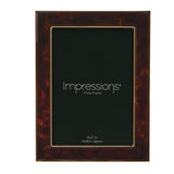 Rectangular photo frame with brown tortoiseshell-effect face and gold-tone metal edges, holding a 5x7 in print, on a plain white background.