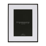 Matt black metal photo frame with white mount, rectangular 7 x 5in window, shown upright on a plain white background.