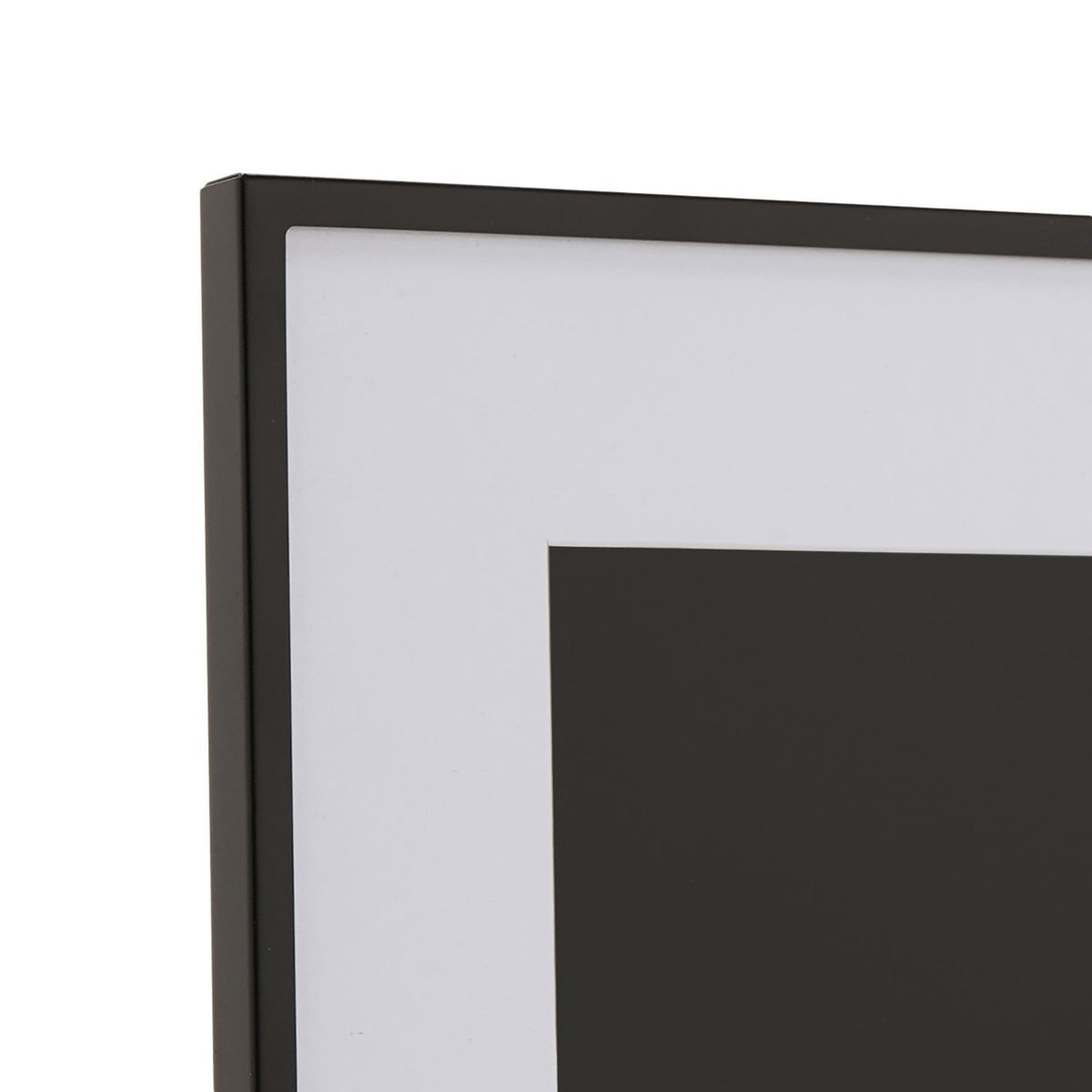 Close-up corner view of the Matt Metal Photo Frame 7 x 5in in black, showing the slim black metal edge, white mount border and rectangular window on a plain background.