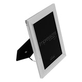 Single rectangular silverplated photo frame with beaded border and stepped moulding, shown at an angle with black velvet back strut, on a white background.