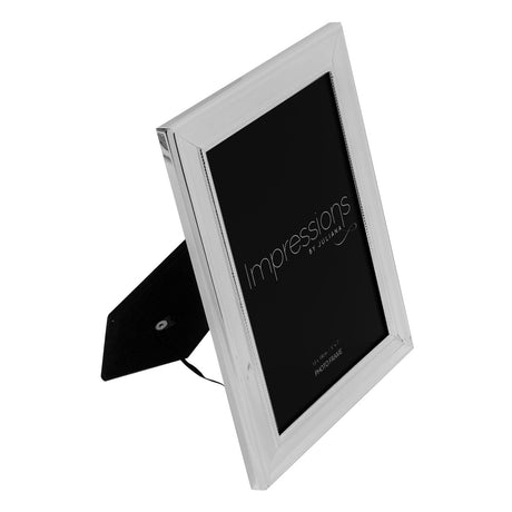 Single rectangular silverplated photo frame with beaded border and stepped moulding, shown at an angle with black velvet back strut, on a white background.