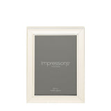 Single beaded silverplated photo frame with strut, rectangular stepped moulding holding a grey 5x7in insert, shown upright on a plain white background.