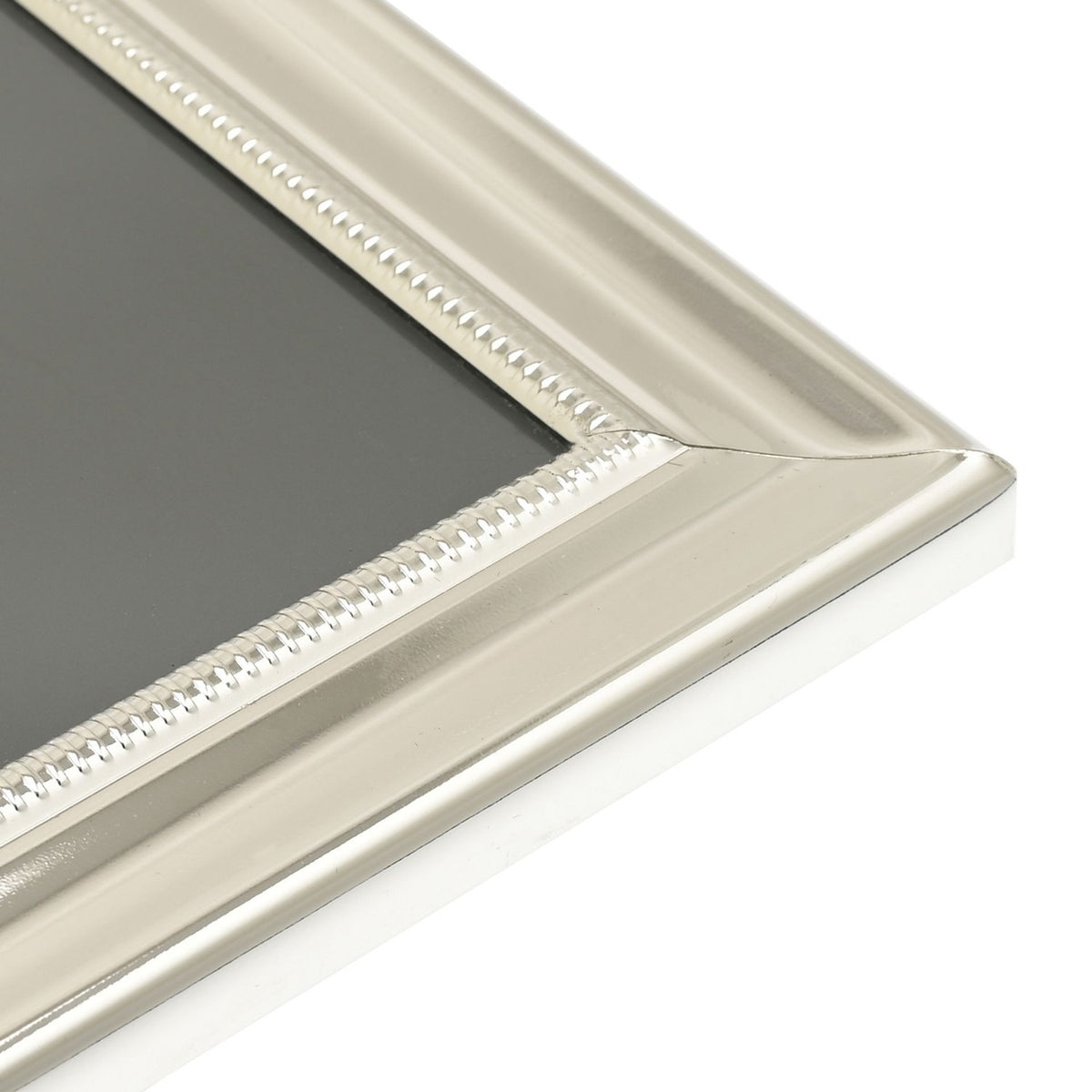 Close-up of a rectangular silverplated photo frame corner showing stepped moulding and a fine beaded border, with high-polish silver finish, on a plain white background.