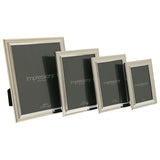Four silverplated rectangular photo frames with beaded borders and stepped moulding in graduated sizes (8x10in, 6x8in, 5x7in, 4x6in), each with a rear strut, shown on a plain white background.