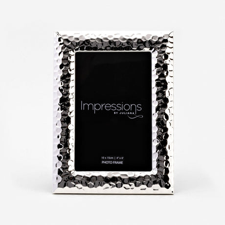 Textured freestanding silverplated photo frame with hammered dimpled border and smooth bevelled edge, holding a 4"x6" rectangular print, shown on a plain white background.