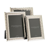 Three rectangular freestanding photo frames in hammered silverplate finish with bevelled edges, shown in 4x6in and 5x7in sizes on a white background.