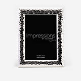 Textured freestanding silverplated photo frame with hammered dimpled border and smooth bevelled edge, rectangular opening for a 5x7" print, on a white background.