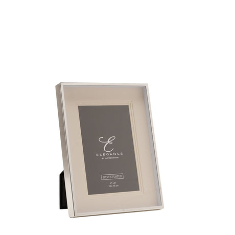 Rectangular silverplated photo frame with a triple layer white mount and polished silver edge, holding a 4" x 6" print, shown on a plain white background.