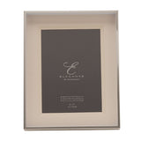 Silverplated rectangular photo frame with a triple layer white mount and polished silver edge, holding a 5 x 7in photo, shown on a plain white background.