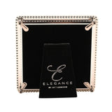 Rear view of the Silverplated Epoxy Beaded Metal Photo Frame in white and silver, showing the black velvet backing, hinged metal stand, and Elegance by Impressions dust bag.