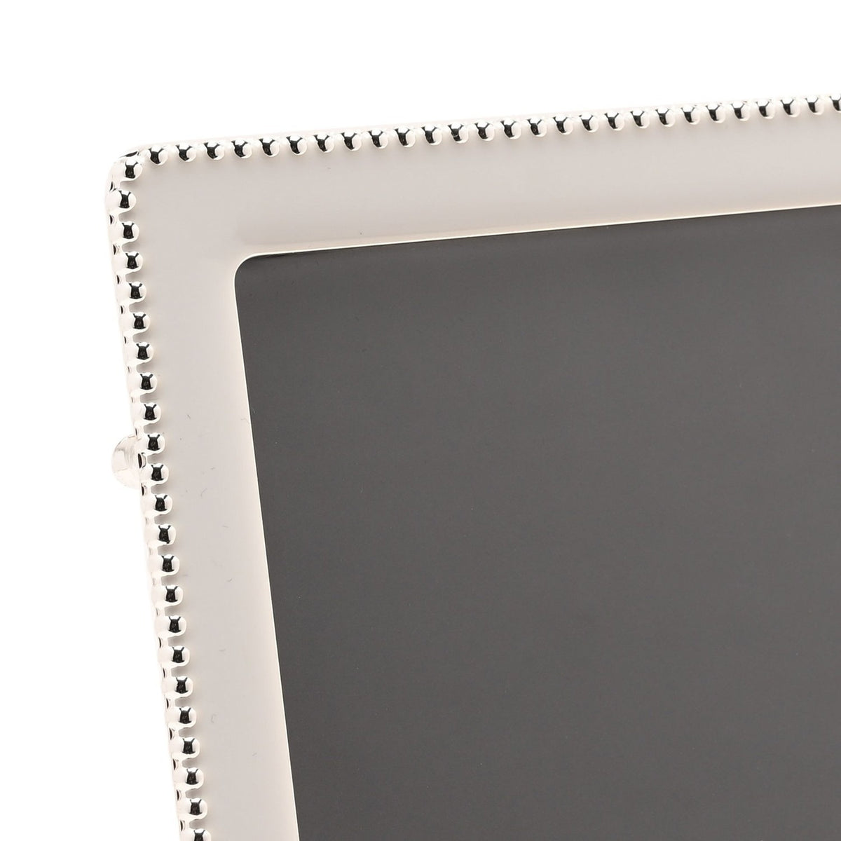Close-up of a rectangular photo frame corner with soft white epoxy border and silverplated metal beaded edge detail, shown against a plain background.