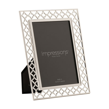 Rectangular photo frame with an openwork lattice border in silver-plated metal, holding a 6 x 4in portrait photo, shown at an angle on a plain white background.