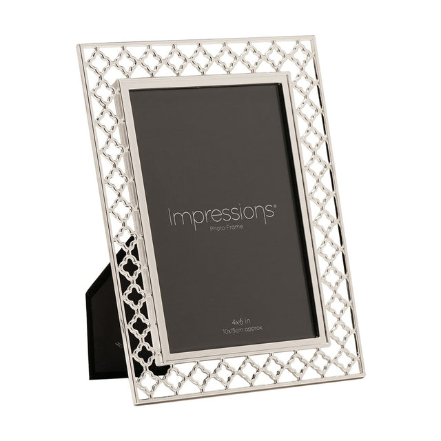 Rectangular photo frame with an openwork lattice border in silver-plated metal, holding a 6 x 4in portrait photo, shown at an angle on a plain white background.