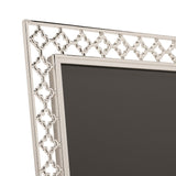 Close-up of the Lattice Cut Silverplated Metal Photo Frame 6 x 4in, showing its silver openwork border with repeating four-petal shapes around a dark insert.
