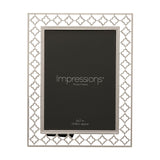 Rectangular photo frame in bright silver-plated metal with a cut-out lattice border of linked four-petal shapes, holding a 5x7in print, shown on a white background.