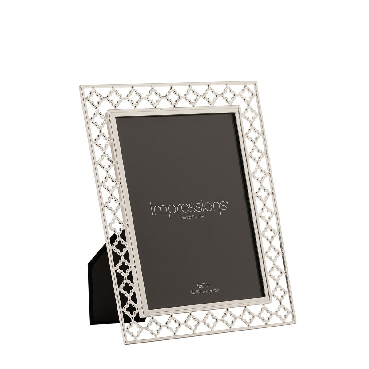 Rectangular silverplated metal photo frame with a cut-out lattice border of four-petal shapes and a plain polished inner edge, holding a 5 x 7in print, shown against a white background.