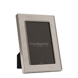 Rectangular silverplated metal photo frame with an art deco scallop pattern border and smooth raised inner rim, shown upright on a plain white background.