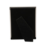 Rectangular silverplated metal photo frame shown from behind, with black velvet backing and fold-out stand, against a plain white background.