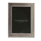 Rectangular silverplated metal photo frame with an Art Deco scallop pattern bordering a smooth raised inner rim, holding a 5x7 in insert, on a white background.