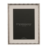 Silver metal photo frame with criss cross patterned border and white mount, holding a 5x7in photo, shown on a plain white background.