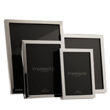 Four narrow rectangular silverplated metal photo frames in varying sizes with polished silver borders, displayed against a plain white background.