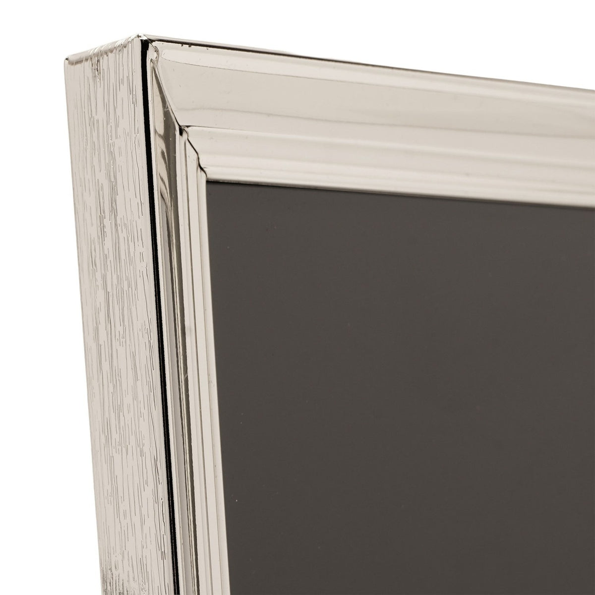 Close-up of a rectangular freestanding photo frame in silverplated metal, showing the moulded, layered profile at the corner against a plain white background.