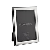Rectangular silver-plated photo frame with a narrow, smooth border holding a 6 x 4in print, shown at an angle on a plain white background.
