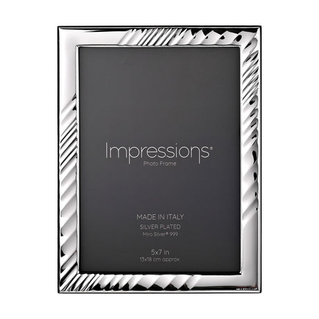 Rectangular silver-plated photo frame with a textured diagonal wave border and smooth inner edge, holding a 7 x 5in print, shown on a plain white background.
