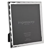 Wavy bevelled rectangular photo frame in silver with a rippled edge, holding a grey 8x10in insert, shown at an angle against a white background.