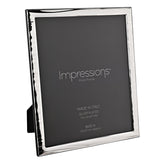 Silverplated narrow wave photo frame with rippled silver border and wood back, holding a grey 8x10in insert, shown at an angle on a white background.
