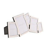 Overlapping multi-aperture photo frame in silver-plated metal with five tilted rectangular openings and black back stand, shown on a plain white background.