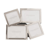 Overlapping multi-aperture photo frame in shiny silver metal with four tilted openings, two square and two landscape, shown on a plain white background.