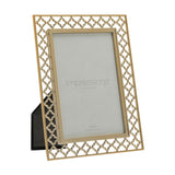 Gold quatrefoil lattice cut metal photo frame, 6 x 4in, rectangular with easel back stand, shown at an angle on a plain white background.