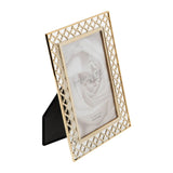 Gold Quatrefoil Lattice Cut Metal Photo Frame, 6 x 4in, with pierced four-lobed pattern border and raised inner edge, shown at an angle with rear stand on a white background.