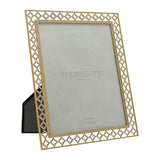 Gold freestanding photo frame with lattice-cut quatrefoil border and easel back, holding a 10 x 8in print, shown angled on a white background.
